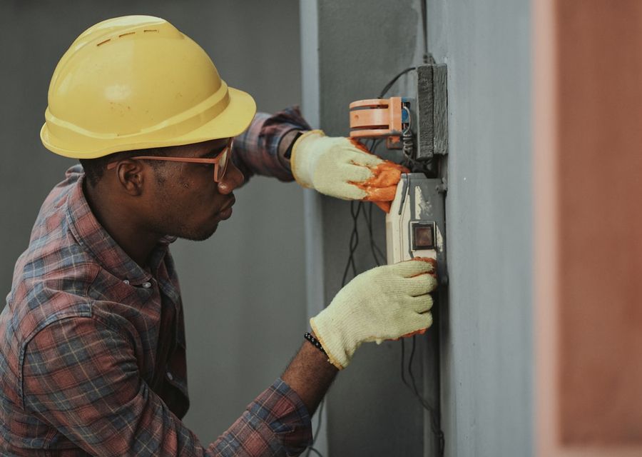 Electrician wiring a distribution point on a building site